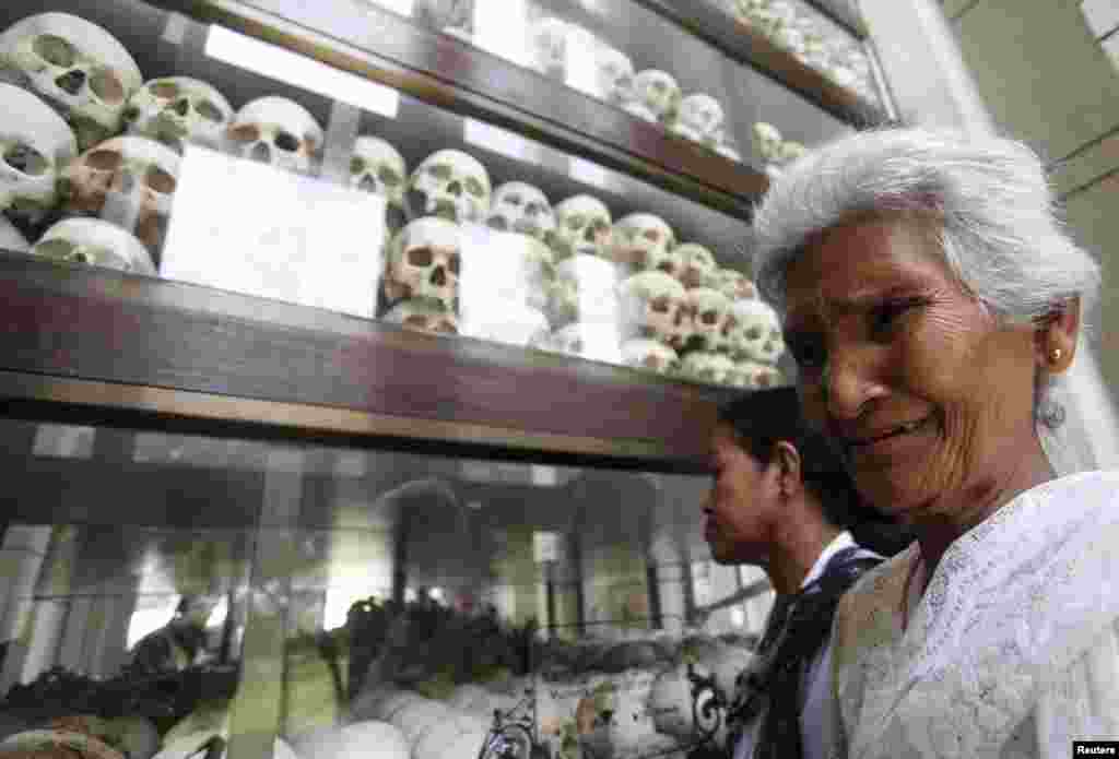 A woman cries in front of the skulls and bones of more than 8,000 victims of the Khmer Rouge regime during a Buddhist ceremony at Choeung Ek, a "Killing Fields" site located on the outskirts of Phnom Penh, Cambodia. Hundreds of Cambodians and monks gathered at the site to commemorate the 40th anniversary of the Khmer Rouge reign.