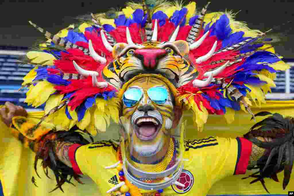 A fan of Colombia cheers prior to a qualifying soccer match between for the FIFA World Cup Qatar 2022 Colombia and Chile in Barranquilla, Colombia.