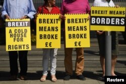 FILE - Activists with the group 'Borders Against Brexit' protest in the border town of Dundalk, Ireland, June 28, 2018.