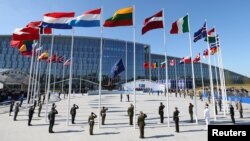 FILE - Flags of NATO member countries fly at the new NATO headquarters in Brussels, Belgium.