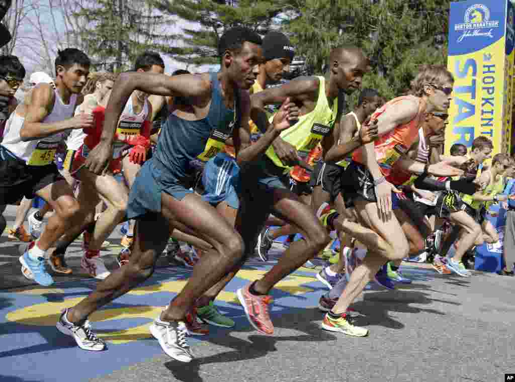 Elite men runners leave the start line in the 118th running of the Boston Marathon, in Hopkinton, Mass., April 21, 2014.