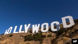 Painting crews set up on the base of the Hollywood Sign in Los Angeles Tuesday, Oct. 2, 2012. The Hollywood sign, built in 1923, was an outdoor ad campaign for a suburban housing development called Hollywoodland. The sign has been painted twice since 1978