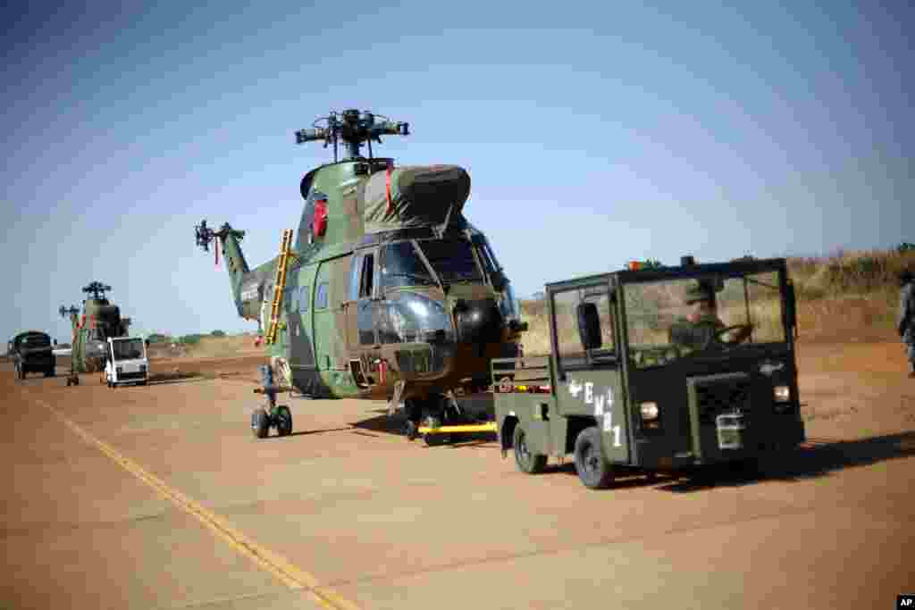 French helicopters are towed to the military side of Bamako's airport, Mali, January 16, 2013.