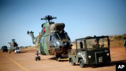 French helicopters are towed to the military side of Bamako's airport, Mali, January 16, 2013.