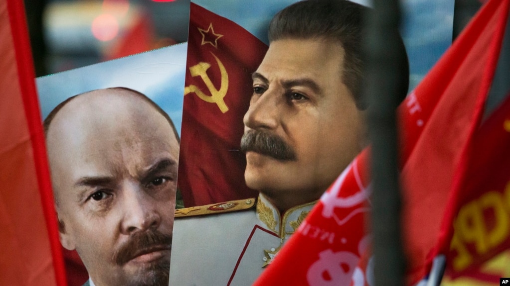 Communist party supporters carry portraits of Soviet founder Vladimir Lenin, left, and Soviet dictator Josef Stalin during a demonstration marking the 100th anniversary of the 1917 Bolshevik revolution in Moscow, Russia, Nov. 7, 2017.