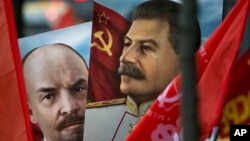 Communist party supporters carry portraits of Soviet founder Vladimir Lenin, left, and Soviet dictator Josef Stalin during a demonstration marking the 100th anniversary of the 1917 Bolshevik revolution in Moscow, Russia, Nov. 7, 2017.