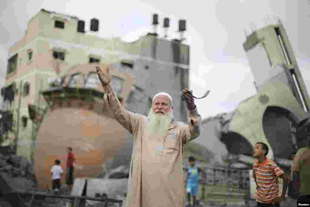 A Palestinian in front of the remains of a mosque that was destroyed in an Israeli air strike before the latest 72-hour truce, in Khan Younis in the southern Gaza Strip, Aug. 11, 2014.