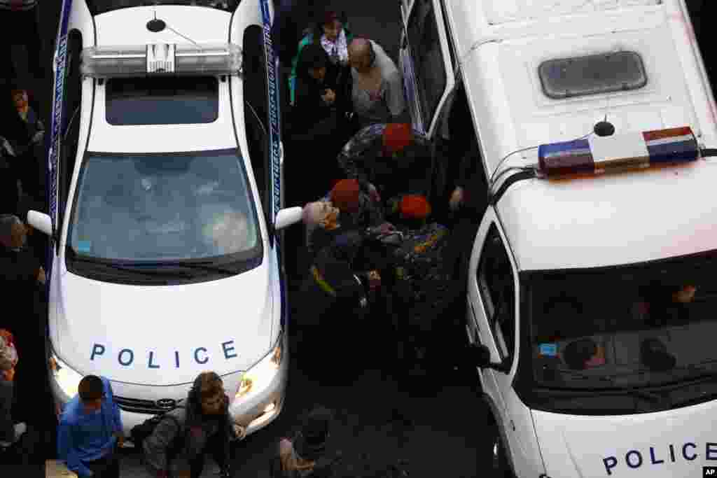 Policemen carry a victim of the explosion of gas-filled balloons during a campaign rally in the central Republic Square in Yerevan, May 4, 2012. An explosion injured at least 144 in central Yerevan on Friday during a campaign rally by Armenia's ruling par