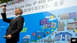 Hans Dietmar Schweisgut, EU ambassador to China, toasts after delivering the opening speech at an event to mark Europe Day in Beijing, May 9, 2016.