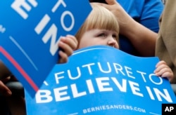 FILE - A young audience member watches Democratic presidential candidate, Sen. Bernie Sanders, I-Vt., speak during a rally in Springfield, Oregon, April 28, 2016.