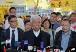 Occupy Central leaders, from right, Benny Tai, Chu Yiu-ming and Chan Kin-man speak before entering a court in Hong Kong, April 9, 2019.
