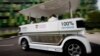 FILE - People ride on a driverless electric vehicle at the Nanyang Technological University (NTU) in Singapore.