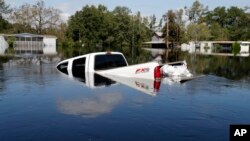A submerged truck sits in floodwaters in the aftermath of Hurricane Florence in Nichols, S.C., Sept. 21, 2018. 