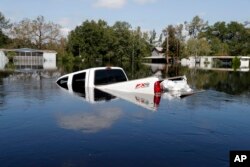 A submerged truck sits in floodwaters in the aftermath of Hurricane Florence in Nichols, S.C., Sept. 21, 2018.
