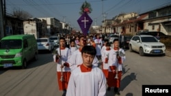 The Palm Sunday procession makes its way toward a government-sanctioned church in Youtong village, Hebei province, China, March 25, 2018.