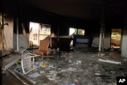 FILE - Glass, debris and overturned furniture are strewn inside a room in the gutted U.S. consulate in Benghazi, Libya, after an attack that killed four Americans, Sept. 12, 2012.