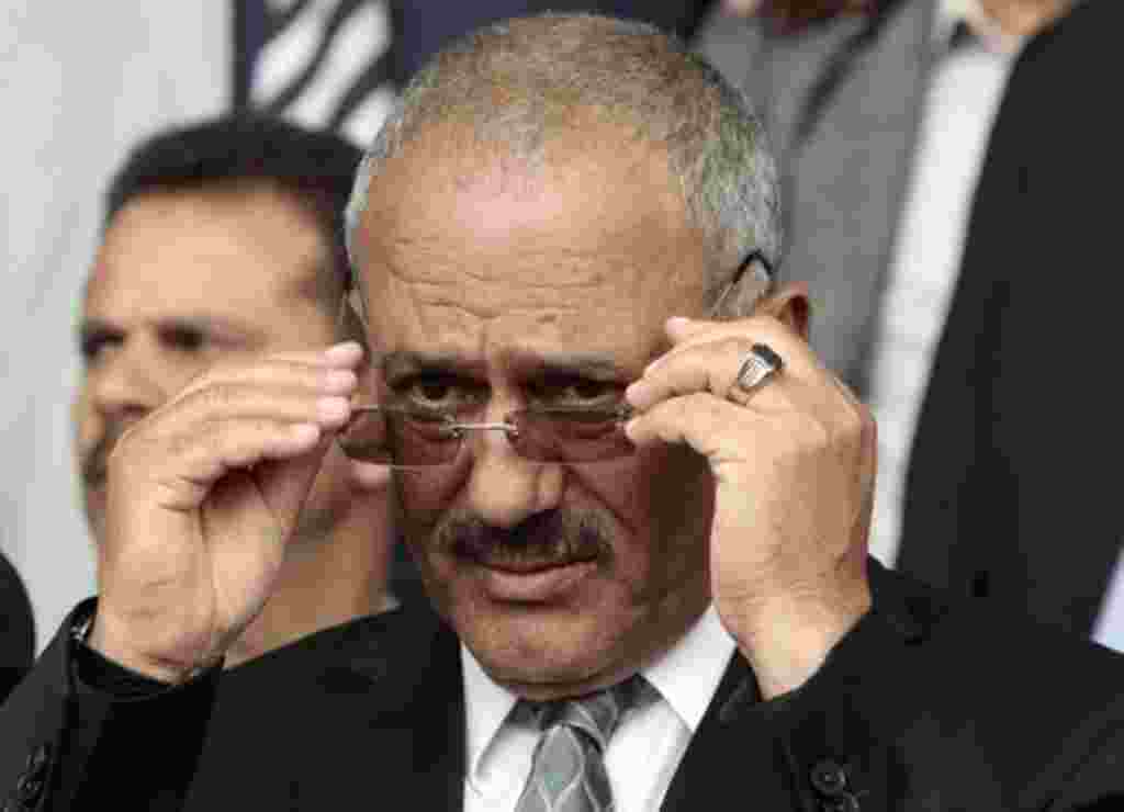Yemen's President Ali Abdullah Saleh adjusts his glasses during a rally in Sanaa April 22, 2011.