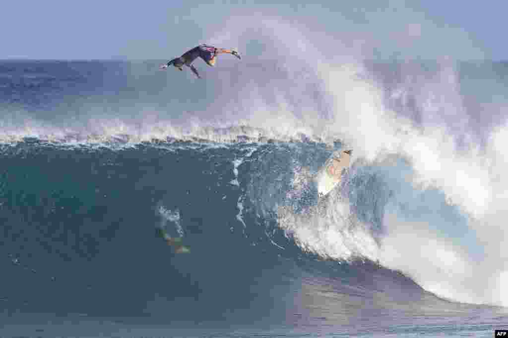 An unknown surfer wipes out during the Vans World Cup of Surfing at Backdoor Pipeline on the north shore of Oahu, Hawaii, Nov. 27, 2019.