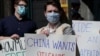 Protesters hold signs as they gather during a rally for Uyghur Freedom in New York, March 22, 2021. 