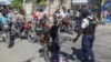 FILE - Police officers man a checkpoint checking for weapons, in the Petion-Ville of Port-au-Prince, Haiti, Nov. 19, 2024. 