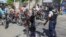 FILE - Police officers man a checkpoint checking for weapons, in the Petion-Ville of Port-au-Prince, Haiti, Nov. 19, 2024.