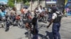 Police officers man a checkpoint checking for weapons, in the Petion-Ville of Port-au-Prince, Haiti, Tuesday, Nov. 19, 2024. 