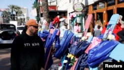 Two days after a U.S. Army veteran drove his truck into the crowded French Quarter on New Year's Day, Raymond Cruz of Tampa, Florida, looks at wooden crosses bearing the photos of victims who were killed, in New Orleans, Louisiana, Jan. 3, 2025.