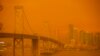 The San Francisco Bay Bridge and city skyline are obscured in orange smoke and haze as seen from Treasure Island in San Francisco, California, Sep. 9, 2020.