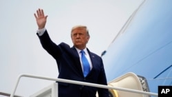 FILE - President Donald Trump waves before boarding Air Force One, at Andrews Air Force Base, Md., Sept. 24, 2020.