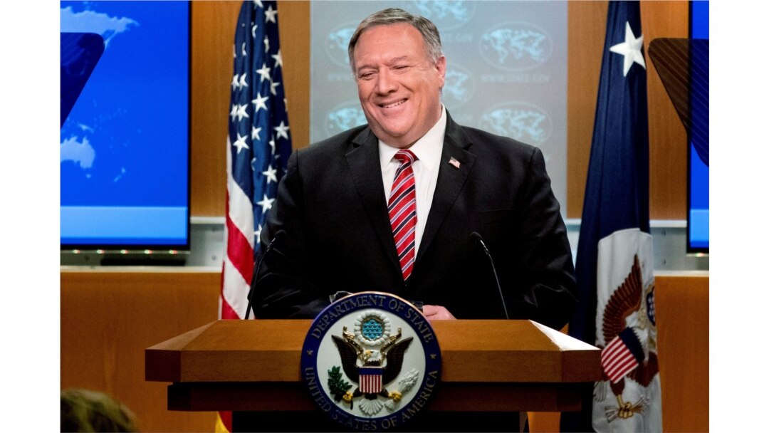FILE - U.S. Secretary of State Mike Pompeo smiles during a news conference at the State Department, in Washington, April 29, 2020.