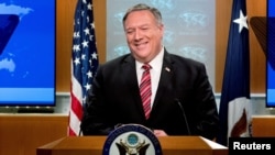 FILE - U.S. Secretary of State Mike Pompeo smiles during a news conference at the State Department, in Washington, U.S., April 29, 2020.