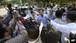 Rong Chhun, rear center, head of the Cambodian Confederation of Unions gives a press conference on a street in Phnom Penh, file photo. 