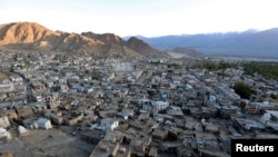 FILE - The sun sets in Leh, the largest town in the region of Ladakh, nestled high in the Indian Himalayas, India, Sept. 26, 2016. 