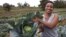 Former reality show contestant Leah Wangari shows cabbages at an agricultural training farm in Limuru, near the capital Nairobi, Kenya, Jan. 17, 2018.