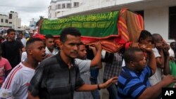 Muslims carry a casket in Mombasa, Kenya, May 4, 2014, after an explosion killed four people at a bus stop on Saturday night. 