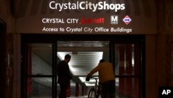 People walk in Crystal City, Va. Washington, D.C.’s subway system serves the Crystal City, Virginia, neighborhood that Amazon chose for one of its headquarters locations.