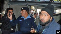 An intelligence official interrogating the suspect, identified as Mumtaz Qadri, Commando of Pakistan's Elite force, right, who allegedly killed Punjab's governor Salman Taseer in Islamabad, 04 Jan 2011