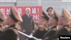 Russian Defense Minister Andrei Belousov and North Korean Defense Minister No Kwang Chol watch a welcome ceremony at Pyongyang Sunan International Airport, North Korea, in this image from video, Nov. 29, 2024. (Russian Defense Ministry/Reuters)