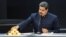 FILE - Venezuela's President Nicolas Maduro touches a gold bar as he speaks during a meeting with the ministers responsible for the economic sector at Miraflores Palace in Caracas, Venezuela, March 22, 2018. 
