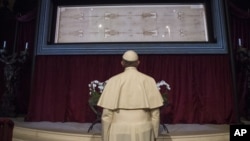 Le pape François prie devant le Saint Suaire de Turin, que les chrétiens catholiques considèrent comme étant la toile funéraire de Jésus, à la cathédrale de Turin, en Italie, le 21 juin 2015. (Photo: AP)