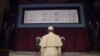 FILE - Pope Francis prays in front of the Holy Shroud of Turin, the 14 foot-long linen revered by Christians as the burial cloth of Jesus, on display at the Cathedral of Turin, Italy, June 21, 2015.