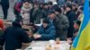 People receive free food during Pro-European Union rally at the Independence Square in Kiev, Ukraine, Dec. 16, 2013.