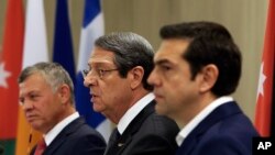 Cyprus' President Nicos Anastasiades, center, talks to the media as Jordan's King Abdullah II, left, and Greek Prime Minister Alexis Tsipras listen during a press conference at the Presidential palace in capital Nicosia, Cyprus, on Tuesday. Jan. 16, 2018.