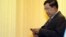 FILE - Cambodia's Prime Minister Hun Sen looks at his smartphone at a ceremony in Phnom Penh.