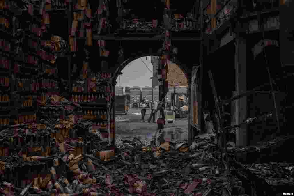Georg Salzner, president of Castello di Amorosa winery, buries his face in his hand outside a warehouse containing thousands of wine bottles destroyed by the Glass Fire in Calistoga, California, Sept. 29, 2020.
