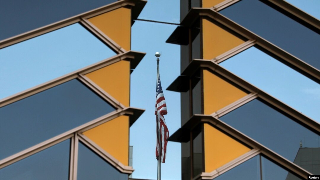 The U.S. flag is reflected on the windows of the U.S. Embassy in Kabul, Afghanistan, July 30, 2021. 