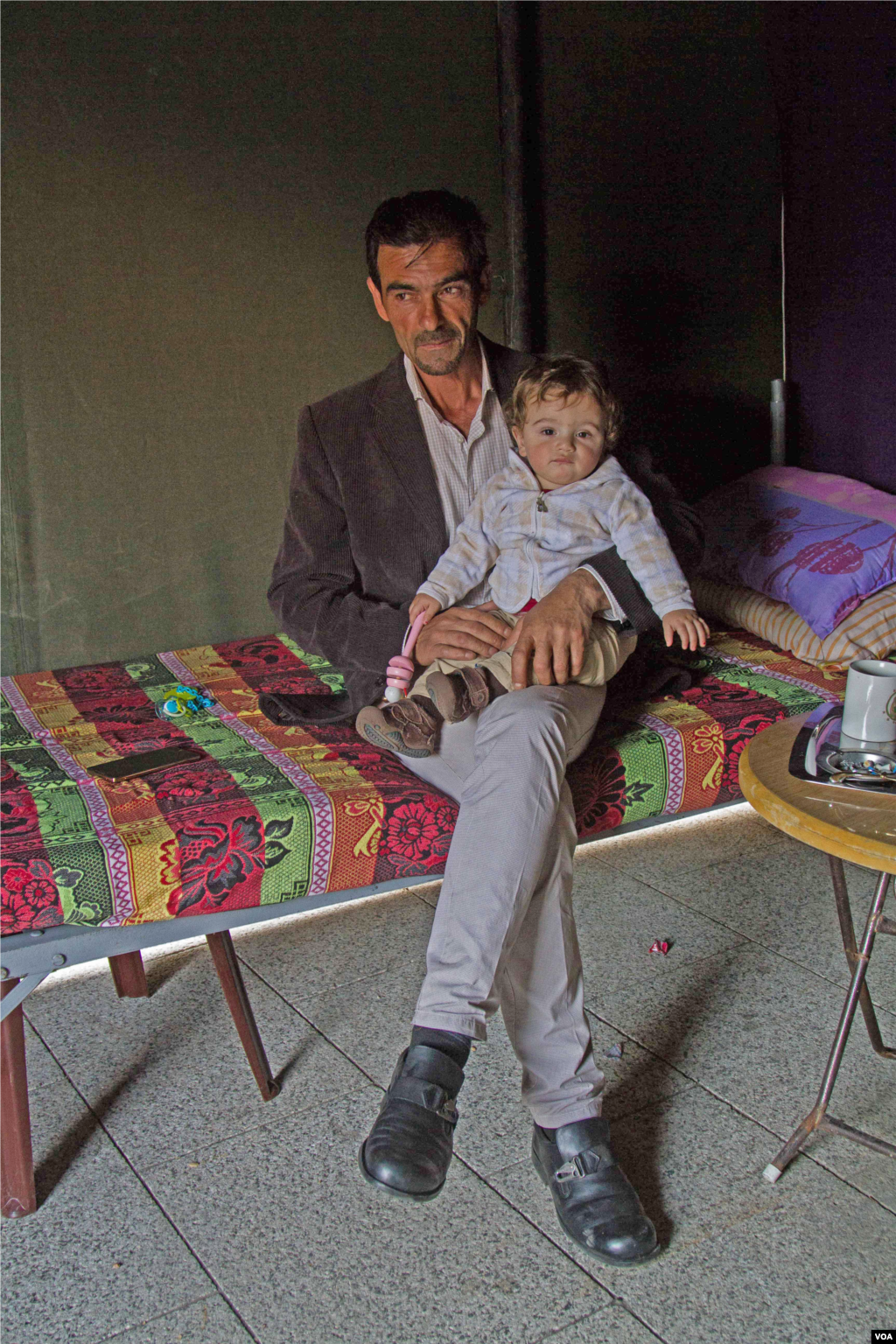 Hussein Youssef with his grandson. The boy&rsquo;s father, Mohammad Youssef, is among those taken captive by the Islamic State militants and the al-Nusra Front. (John Owens/VOA)