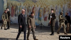 President Joe Biden walks with Ukrainian President Volodymyr Zelenskyy at St. Michael's Golden-Domed Cathedral on a surprise visit, Feb. 20, 2023, in Kyiv.