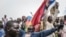 Russians and Malian flags are waved by protesters in Bamako during a demonstration against French influence in the country on May 27, 2021. (Michele Cattani/AFP)