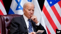 FILE - President Joe Biden listens as he and Israeli Prime Minister Benjamin Netanyahu participate in an expanded bilateral meeting with Israeli and U.S. government officials, Oct. 18, 2023, in Tel Aviv. 